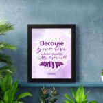 Bible wall art featuring Psalm 63:3 with playful text in purple and pink on a lavender background. displayed on the wall in a black frame