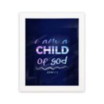 Infidu I Am A Child Of God wall art featuring soft glowing text in pink and blue on a dark blue background. hung on the wall in a black frame