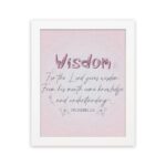 Christian wall art with the quote from Proverbs 2:6, featuring the word "Wisdom" in script on a soft pink background. hung on the wall in a white frame