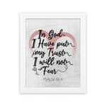 In God I Have Put My Trust, I Will Not Fear Psalm 56:4 Bible Verse Wall Art with pink watercolor arc and black frame. hung on the wall in a white frame