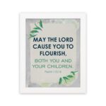 Infidu Christian wall art featuring Psalm 115:14 with bold text, green highlights, and leaf designs on a light gray background. hung on the wall in a white frame