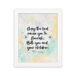 Christian wall art featuring Psalm 115:14 in black cursive on a pastel watercolor background with floral designs. hung on the wall in a white frame