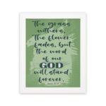 Christian wall art featuring Isaiah 40:8 with dark green and black text on a light green background. hung on the wall in a white frame