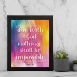 Wall art featuring the verse For with God nothing shall be impossible from Luke 1:37, designed with a colorful watercolor background. displayed on the wall in a black frame