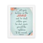 Cast Your Burden on the Lord Psalm 55:22 Christian wall art with teal and coral text on a mint green background with floral accents. hung on the wall in a white frame