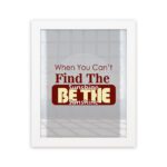 Infidu When You Can't Find The Sunshine Be The Sunshine wall art with a gray and white background and red text and white frame hung on the wall Inspiring decor for any workspace.