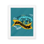 Infidu When You Can't Find the Sunshine, Be the Sunshine Office Wall Art featuring black, yellow, and blue text on a light blue background with decorative elements, framed in white hung on the wall. Perfect for inspirational quote wall art, office wall art, and home decor.