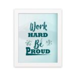 Work Hard Be Proud office wall art featuring green text with decorative elements on a white background, framed in white hung on the wall. Perfect for home offices.