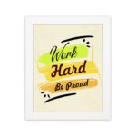 Infidu motivational quotes wall art featuring Work Hard Be Proud on a light white background with light gray flowers and a white frame displayed on the wall. the inspiring success