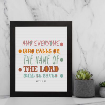 Bible wall art with Acts 2:21 verse, featuring pastel polka dots and bold text, designed to inspire and uplift your home decor. displayed on the wall in a black frame