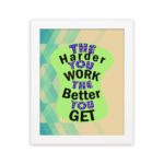 Infidu The Harder You Work The Better You Get wall art with a sandal-colored background green design, and white frame hung on the wall. Inspiring decor for home offices and workspaces.