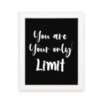 Infidu motivational quotes wall art featuring You Are Your Only Limit on a dark black background and white frame hung on the wall. Perfect for inspiring your workspace.