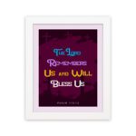 Infidu Bible Wall Art with the text The Lord Remembers Us and Will Bless Us in blue, yellow, and white on a purple background. hung on the wall in a white frame