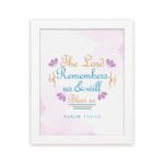 Wall art featuring The Lord Remembers Us And Will Bless Us Psalm 115:12 in pastel colors with leaf accents on a soft background. hung on the wall in a white frame