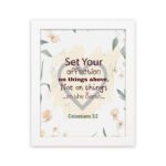 Colossians 3:2 Bible verse wall art with floral design and bold lettering, featuring the words Set Your Affection on Things Above. hung on the wall in a white frame