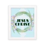 Infidu Jesus Christ Bible Wall Art with JESUS CHRIST text in a mint blue background surrounded by a floral wreath. hung on the wall in a black frame