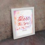 Bless The Lord O My Soul Psalm 103:1 Christian Wall Art with pastel colors and gradient script. displayed on the wall in a white frame