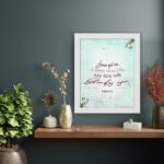 Because Your Love Is Better Than Life Psalm 63:3 Bible Verse Wall Art with soft blue background and floral accents. displayed on the wall in a white frame