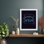 Bible wall art featuring the phrases Start With Jesus, Stay With Jesus, and End With Jesus in white and light blue text on a dark background. displayed on the wall in a white frame