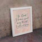 Wall art featuring the quote In God I Have Put My Trust I Will Not Fear from Psalm 56:4 in a bold, playful font. displayed on the wall in a white frame