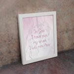 Christian wall art featuring Psalm 56:4, with soft pink background and elegant script font. Perfect for home decor. displayed on the wall in a white frame