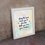 Christian wall art featuring Psalm 115:14 in black cursive on a pastel watercolor background with floral designs. displayed on the wall in a white frame