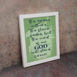 Christian wall art featuring Isaiah 40:8 with dark green and black text on a light green background. displayed on the wall in a white frame