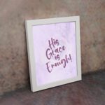 His Grace Is Enough Bible Wall Art with purple text on a lilac background. displayed on the wall in a white frame