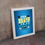 Infidu Dream Big Work Hard Make It Happen wall art with a blue background white, yellow, and black text, and a white frame on the wall. Inspiring decor for home offices and workspaces.