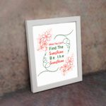 Infidu When You Can't Find The Sunshine Be The Sunshine wall art with a white background and red floral accents and white frame on the wall Inspiring decor for home offices.