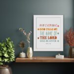 Bible wall art with Acts 2:21 verse, featuring pastel polka dots and bold text, designed to inspire and uplift your home decor. displayed on the wall in a white frame