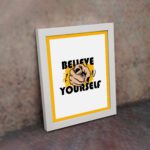 Inspirational quote wall art with "Believe In Yourself" on a white and yellow background and white framed on the wall. Perfect for motivating your workspace.