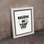 Inspirational quote wall art featuring Believe In Yourself on a white background and white framed on the wall. Perfect for motivating your home office.