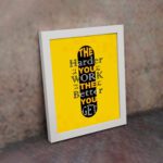 Infidu The Harder You Work The Better You Get wall art with a yellow background and dark yellow and white text with black shadow and white frame on the wall. Inspiring decor for home offices and workspaces.