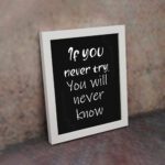 Infidu motivational quotes wall art featuring If You Never Try You Will Never Know on a dark black background and white frame on the wall. Perfect for inspiring your workspace.