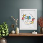 God Is Within Her She Will Not Fall Psalm 46:5 Bible Verse Wall Art with colorful flowers and modern design displayed on the wall in a white frame