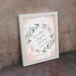 Infidu Set Your Affection On Things Above Bible Wall Art with floral wreath and pink background. displayed on the wall in a white frame