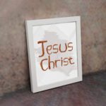 Jesus Christ Bible wall art with hand-drawn brown lettering and a minimalist white-gray watercolor background in a black frame. displayed on the wall in a white frame