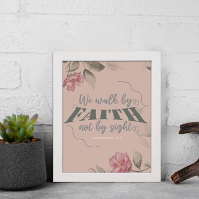 We Walk By Faith Not By Sight Christian Wall Art with pink roses and gray leaves on a soft pink background displayed on the wall in a white frame.