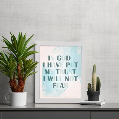 Infidu Psalm 56:4 Christian Wall Art - In God I Have Put My Trust I Will Not Fear with teal text and blue watercolor background. displayed on the table in a white frame