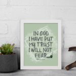 In God I Have Put My Trust, I Will Not Fear Psalm 56:4 bold Christian wall art with green background and brushstroke lettering displayed on the wall in a white frame