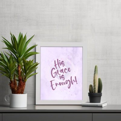 His Grace Is Enough Bible Wall Art with purple text on a lilac background. displayed on the table in a white frame