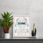 Cast Your Burden on the Lord Psalm 55:22 Christian Wall Art with palm leaf accents and turquoise text on a beige background. displayed on the table in a white frame