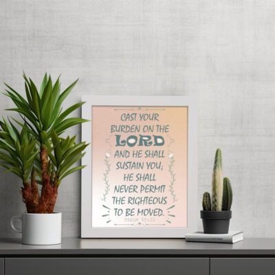 Cast Your Burden on the Lord Psalm 55:22 Bible verse wall art with teal lettering and soft peach background, Christian home decor. displayed on the table in a white frame