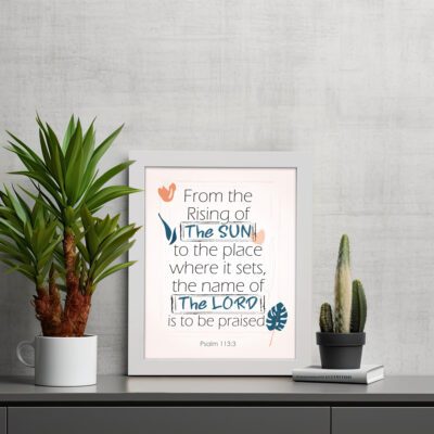 Bible verse wall art displaying From the Rising of the Sun to the Place Where It Sets, The Name of the Lord Is to Be Praised. displayed on the table in a white frame