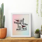 Infidu Don't Think Why, Think Why Not wall art with a red flower design a light blue, gray, and light pink background, and a white frame on the table. Inspiring decor for home offices and workspaces.