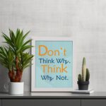 Infidu Don't Think Why, Think Why Not wall art with a red flower design light blue and gray background, and a white frame on the table. Inspiring decor for home offices and workspaces.