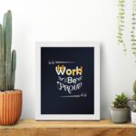 Infidu Work Hard Be Proud office wall art featuring motivational quotes on a navy blue background and a white frame hung on the table. Perfect for home offices and study areas.