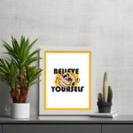 Inspirational quote wall art with "Believe In Yourself" on a white and yellow background and white framed on the table. Perfect for motivating your workspace.