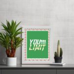 Infidu motivational quotes wall art featuring You Are Your Only Limit on a green corner with a red flower background white framed on the table. inspire your workspace